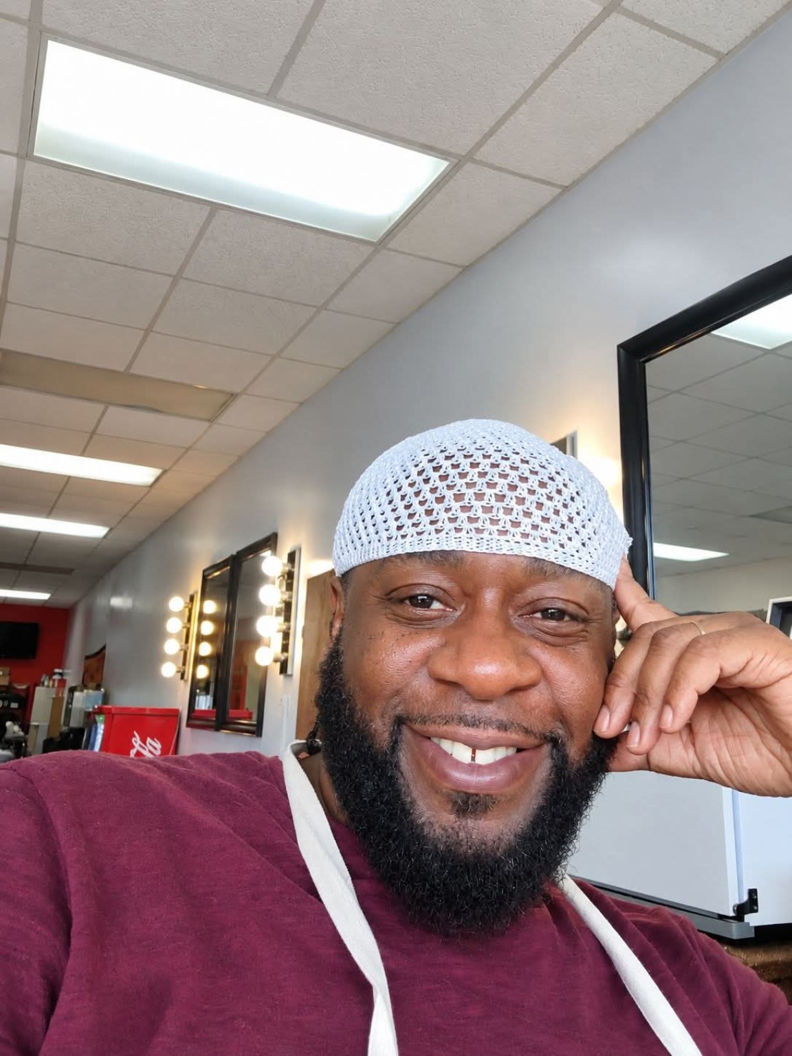 Smiling guest inside Styles of the Nile barber shop
